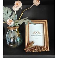 goudkleurige fotolijst vogel staand